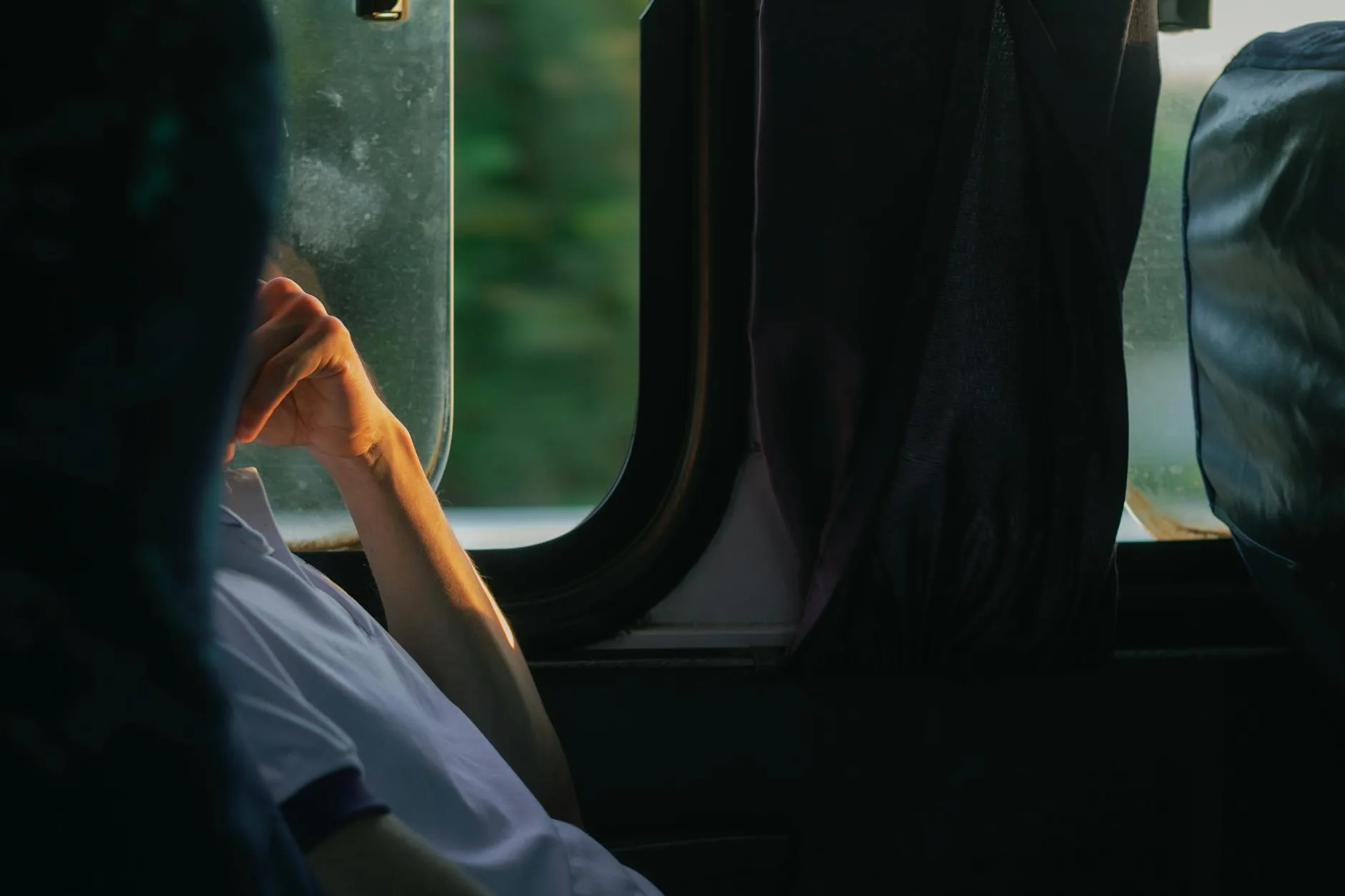 passenger sitting by open window in bus